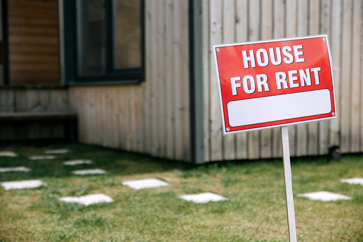 House for rent sign in front of a home
